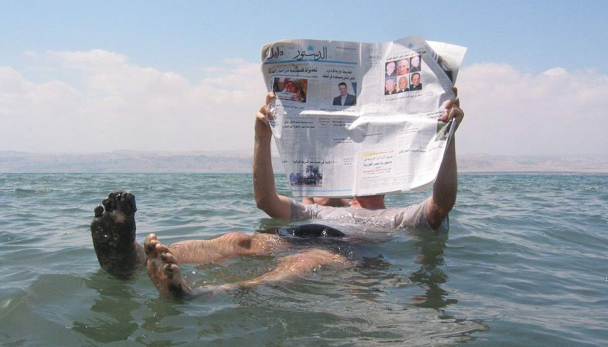 Places to See Before They Have Vanished: Reading newspaper in the Dead Sea