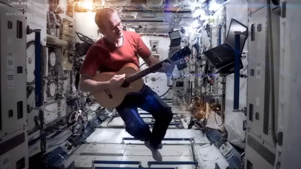 Why do astronauts float in space? Photo: Chris Hadfield, the ex-commander of the International Space Station while recording a revised cover version of David Bowie's famous song Space Oddity on board.