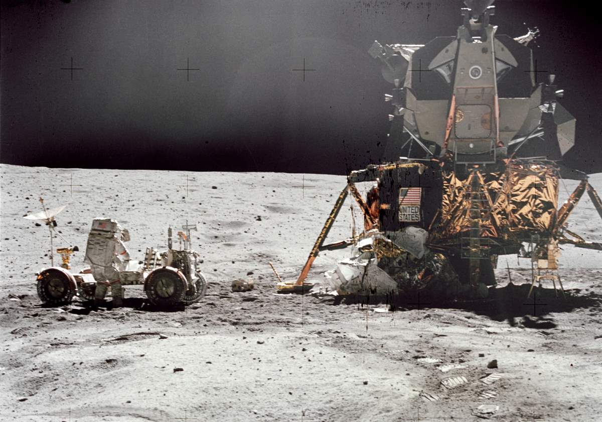 John W. Young, commander of the Apollo 16 lunar landing mission, works at the Lunar Roving Vehicle (LRV) 