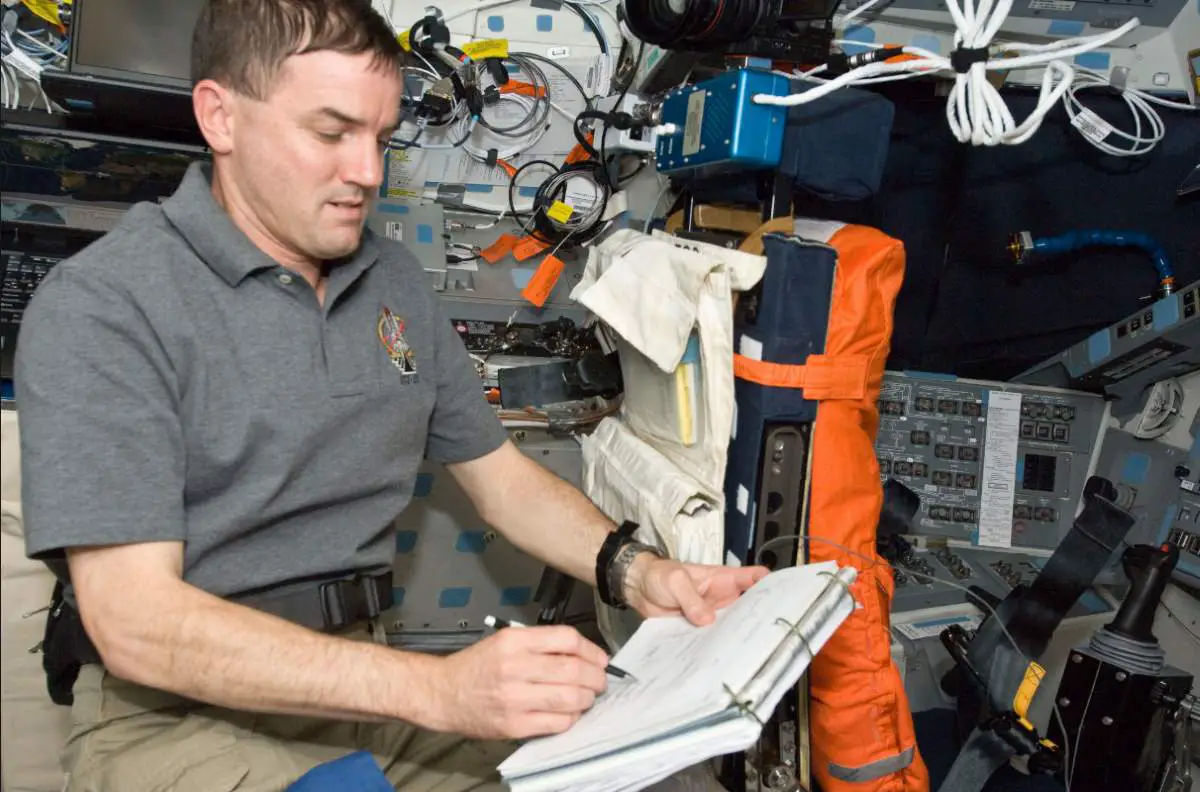 Astronaut using space pen