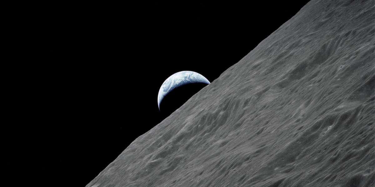 Crescent Earth rises above the lunar horizon - Apollo 17 photo