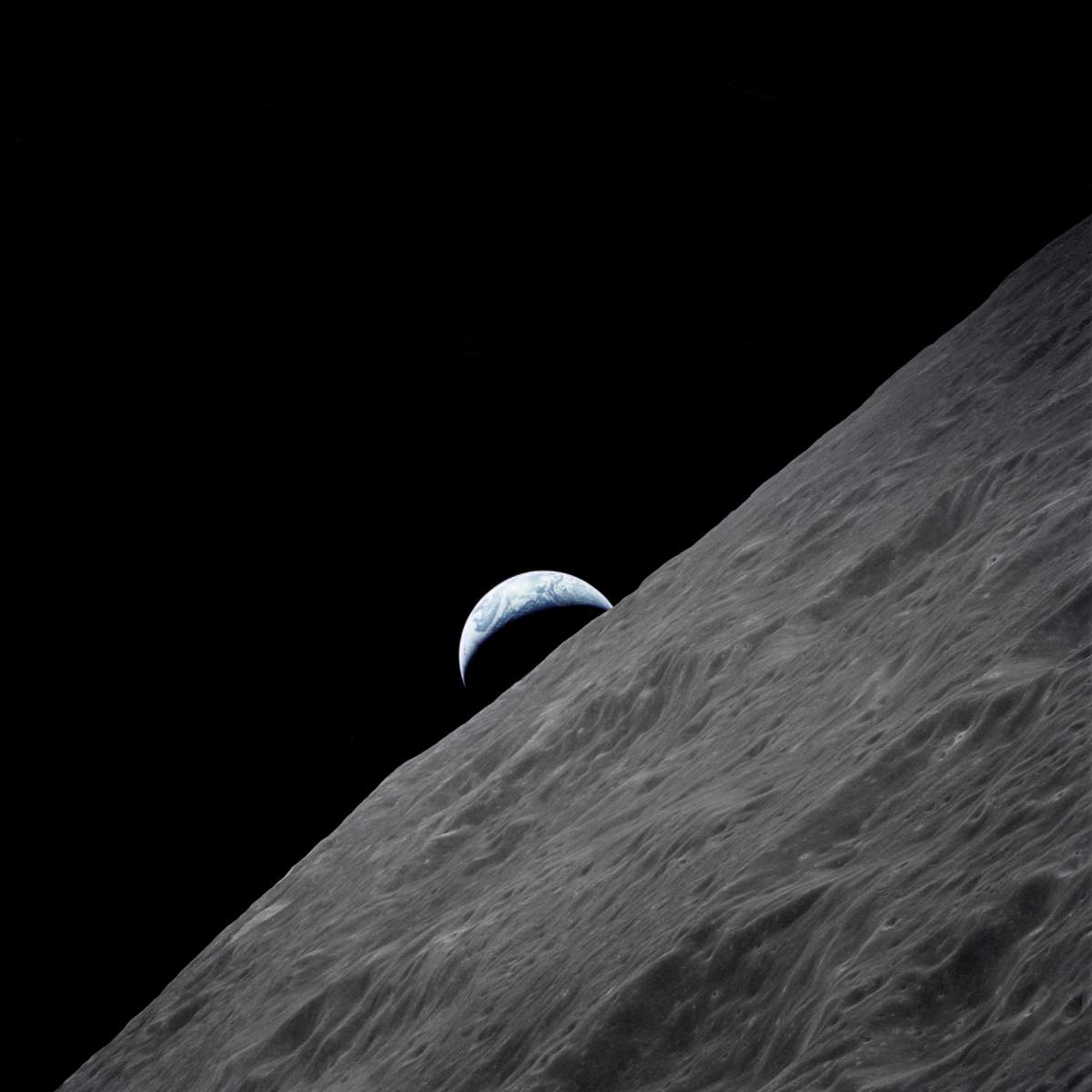 Crescent Earth rises above the lunar horizon - Apollo 17 photo
