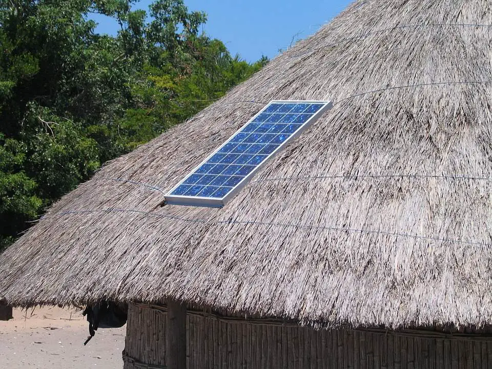 Solar panels atop a roof of a hut