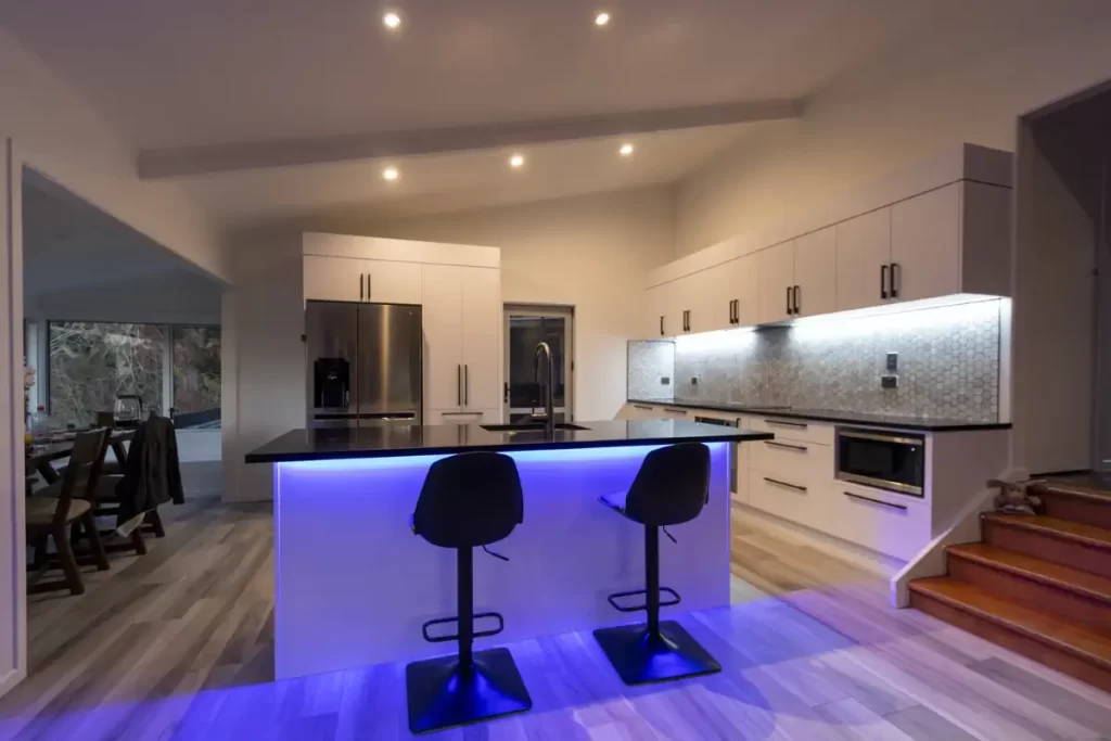 A modern white kitchen with led strip lighting