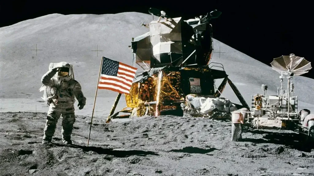 Apollo 15 Lunar Module Pilot (LMP) James B. Irwin salutes the United States flag on the Moon. Lunar Roving Vehicle is parked near the Lunar Module (LM).